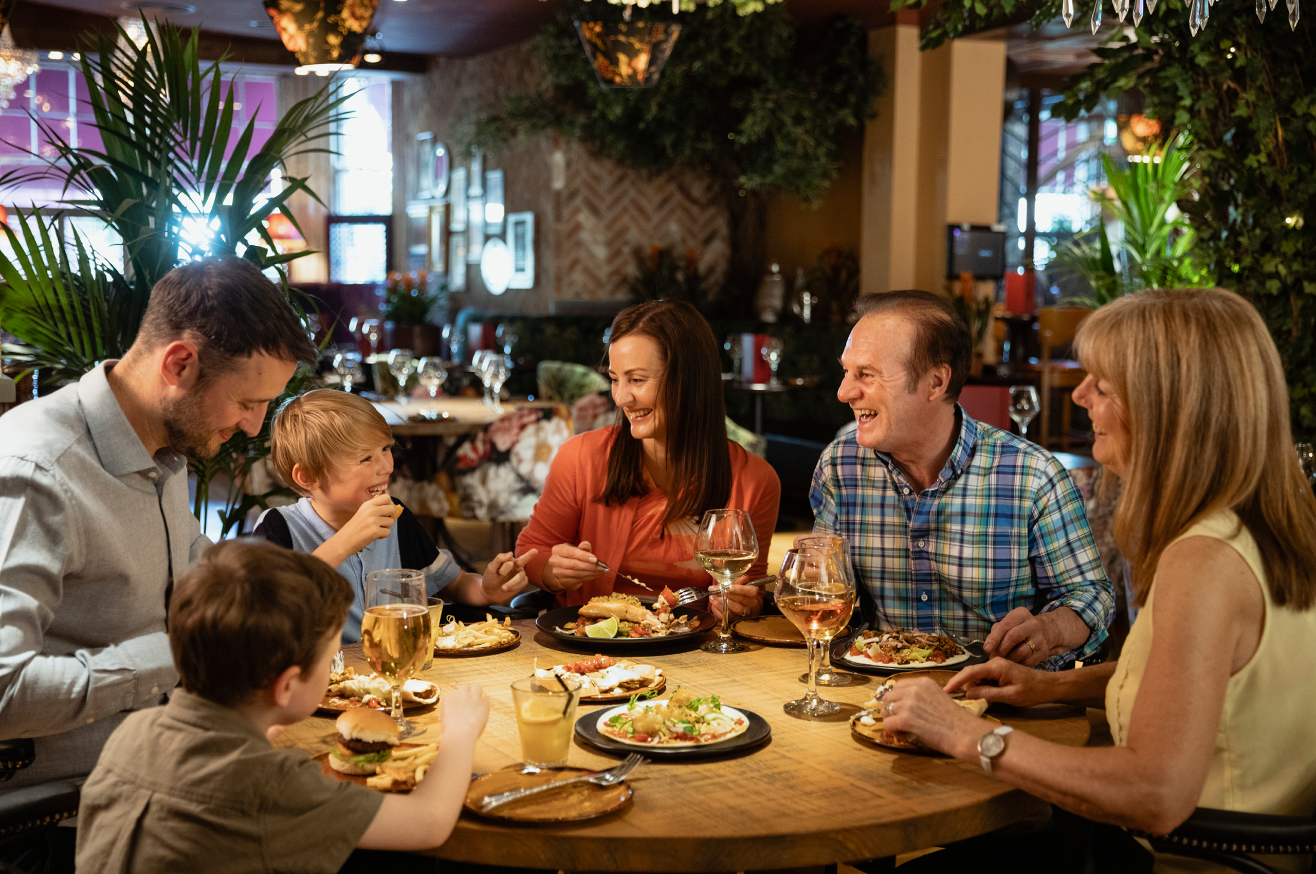 Family enjoying a meal at a restaurant.